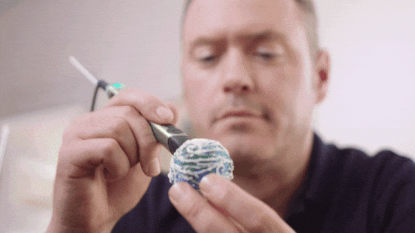 Man holding toothbrush and toothpaste in 3D pen art.