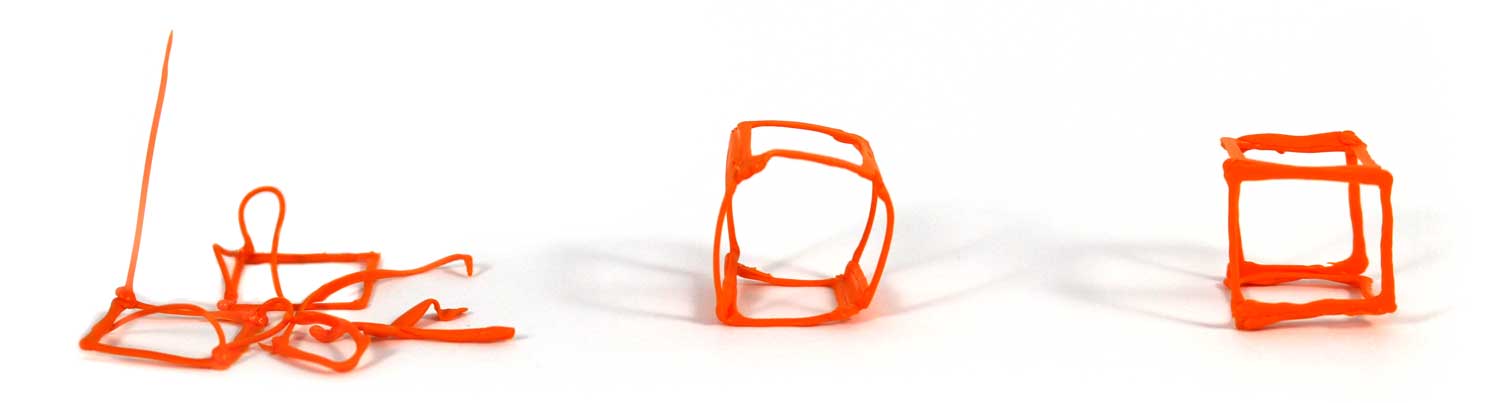 3D pen art: Three orange cell phones on white surface.